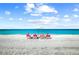 Relaxing beach view with lounge chairs and umbrella at 531 Latitude Ln, Osprey, FL 34229