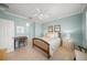 Guest bedroom with a wooden bed frame, light blue walls, and ample natural light at 531 Latitude Ln, Osprey, FL 34229
