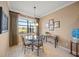 Charming breakfast nook with glass table and seating for four, overlooking the golf course at 531 Latitude Ln, Osprey, FL 34229