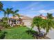 Single story home with palm trees and manicured lawn at 531 Latitude Ln, Osprey, FL 34229