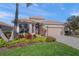 Single-story home with attached garage and lush landscaping at 531 Latitude Ln, Osprey, FL 34229