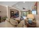 Bright living room featuring a TV, comfortable sofas, and a view to the backyard at 531 Latitude Ln, Osprey, FL 34229