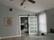 Bright bedroom with a barn door leading to the ensuite bathroom at 5317 19Th S Ave, Gulfport, FL 33707