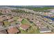 Aerial view of a community with houses, roads, and a lake at 5439 Taliaferro Ct, Palmetto, FL 34221