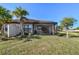 Landscaped backyard featuring a home with a screened patio at 5439 Taliaferro Ct, Palmetto, FL 34221