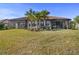 Large backyard with home featuring a screened patio at 5439 Taliaferro Ct, Palmetto, FL 34221