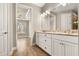 Double vanity bathroom with granite countertop and view of bedroom at 5439 Taliaferro Ct, Palmetto, FL 34221