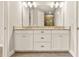 Modern bathroom boasts double vanity, granite countertop, and stylish fixtures at 5439 Taliaferro Ct, Palmetto, FL 34221