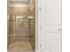 Spa-like bathroom with a large glass shower and neutral tile at 5439 Taliaferro Ct, Palmetto, FL 34221