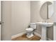 Elegant powder room with pedestal sink and oval mirror at 5439 Taliaferro Ct, Palmetto, FL 34221