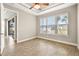 Bright bedroom with wood-look tile floors and sliding glass door to patio at 5439 Taliaferro Ct, Palmetto, FL 34221