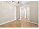 Bright bedroom with wood-look tile floors and access to hallway at 5439 Taliaferro Ct, Palmetto, FL 34221