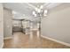 Bright dining room with modern chandelier and view of kitchen at 5439 Taliaferro Ct, Palmetto, FL 34221