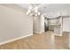 Bright dining room with modern chandelier and view of kitchen at 5439 Taliaferro Ct, Palmetto, FL 34221