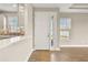Bright and airy entryway with white door and view into the living area at 5439 Taliaferro Ct, Palmetto, FL 34221