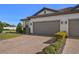 Two-car garage with paver driveway and landscaping at 5439 Taliaferro Ct, Palmetto, FL 34221