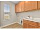 Laundry room with wooden cabinets and countertop at 5439 Taliaferro Ct, Palmetto, FL 34221