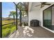 Relaxing screened patio with built-in grill and paver stones at 5439 Taliaferro Ct, Palmetto, FL 34221