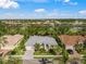 Single-Gathering house with a gray tile roof in a residential community with golf course views at 557 Marsh Creek Rd, Venice, FL 34292