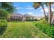 Large backyard with a view of the home and green grass at 557 Marsh Creek Rd, Venice, FL 34292