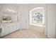 Bathroom boasts double vanity, soaking tub, and large window at 557 Marsh Creek Rd, Venice, FL 34292