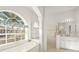 Spa-like bathroom with a soaking tub and walk-in shower at 557 Marsh Creek Rd, Venice, FL 34292