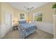 Bright bedroom with floral bedding and a ceiling fan at 557 Marsh Creek Rd, Venice, FL 34292