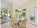 Breakfast nook with glass table and chairs, overlooking pool at 557 Marsh Creek Rd, Venice, FL 34292