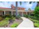 Elegant clubhouse entrance with landscaped walkway at 557 Marsh Creek Rd, Venice, FL 34292