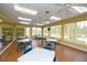 Bright and airy community room with tables, chairs, and a view of the pool at 557 Marsh Creek Rd, Venice, FL 34292