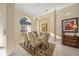 Elegant dining room featuring a glass table, chandelier, and rich decor at 557 Marsh Creek Rd, Venice, FL 34292