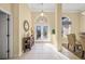 Bright and spacious entryway with tiled floors and a view into the dining area at 557 Marsh Creek Rd, Venice, FL 34292