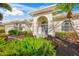 One-story house with a teal front door and manicured landscaping at 557 Marsh Creek Rd, Venice, FL 34292