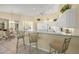 Bright and airy kitchen with white cabinets and a breakfast bar at 557 Marsh Creek Rd, Venice, FL 34292