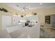 Spacious kitchen featuring white cabinets, granite countertops, and breakfast bar at 557 Marsh Creek Rd, Venice, FL 34292