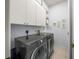 Laundry room with LG washer and dryer and upper cabinets at 557 Marsh Creek Rd, Venice, FL 34292