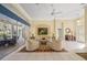 Spacious living room with comfortable seating, large windows, and a view of the pool at 557 Marsh Creek Rd, Venice, FL 34292