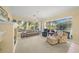 Living room with comfy seating and access to pool views at 557 Marsh Creek Rd, Venice, FL 34292