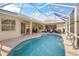 Inviting screened pool and patio area with tranquil water feature at 557 Marsh Creek Rd, Venice, FL 34292