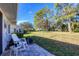 Relaxing patio with rocking chair, overlooking a grassy backyard at 5828 Garden Lakes Dr, Bradenton, FL 34203