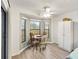 Bright dining area with wood table and large windows at 5857 Pauma Pl, Sarasota, FL 34232