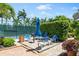 Patio area with grill and seating near tennis courts at 5916 Midnight Pass Rd # 103, Sarasota, FL 34242