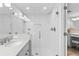 Large bathroom with a walk-in shower, double sinks, and white subway tile at 5916 Midnight Pass Rd # 103, Sarasota, FL 34242