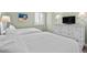 Two twin beds, a dresser, and window with plantation shutters at 5916 Midnight Pass Rd # 103, Sarasota, FL 34242