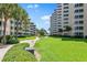 Landscaped courtyard with walkway and building views at 5916 Midnight Pass Rd # 103, Sarasota, FL 34242