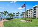 Ocean view, grassy lawn, and a bench at 5916 Midnight Pass Rd # 103, Sarasota, FL 34242