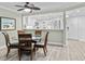 Charming dining area with a glass-top table and four chairs at 5916 Midnight Pass Rd # 103, Sarasota, FL 34242