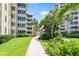 Grounds of the community showing a pathway, lush landscaping, and building exteriors at 5916 Midnight Pass Rd # 103, Sarasota, FL 34242