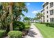 Landscaped grounds with a brick pathway leading to the beach at 5916 Midnight Pass Rd # 103, Sarasota, FL 34242