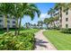 Landscaped grounds with a brick pathway and lush tropical foliage at 5916 Midnight Pass Rd # 103, Sarasota, FL 34242